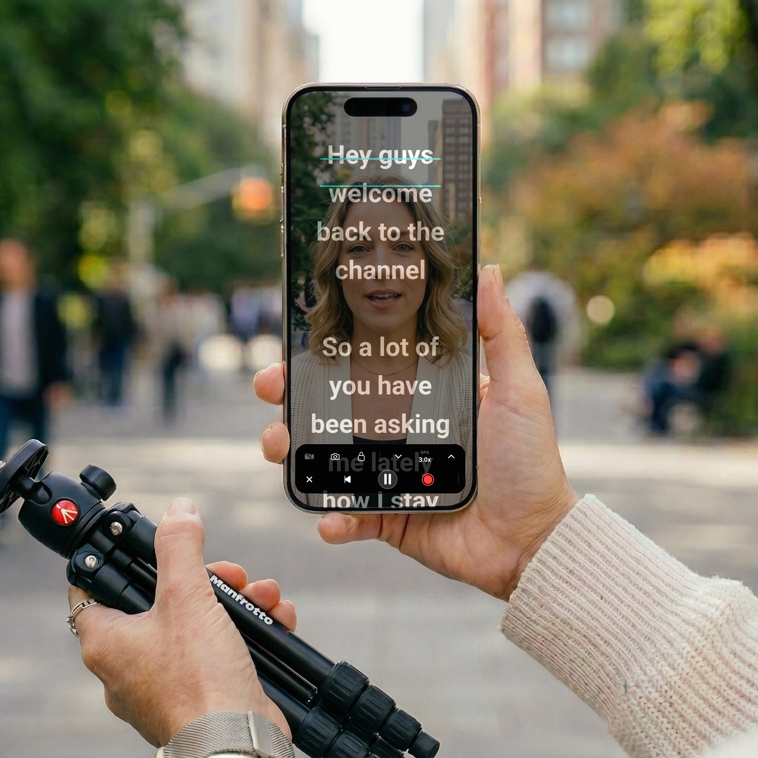 An influencer using a teleprompter outdoors.